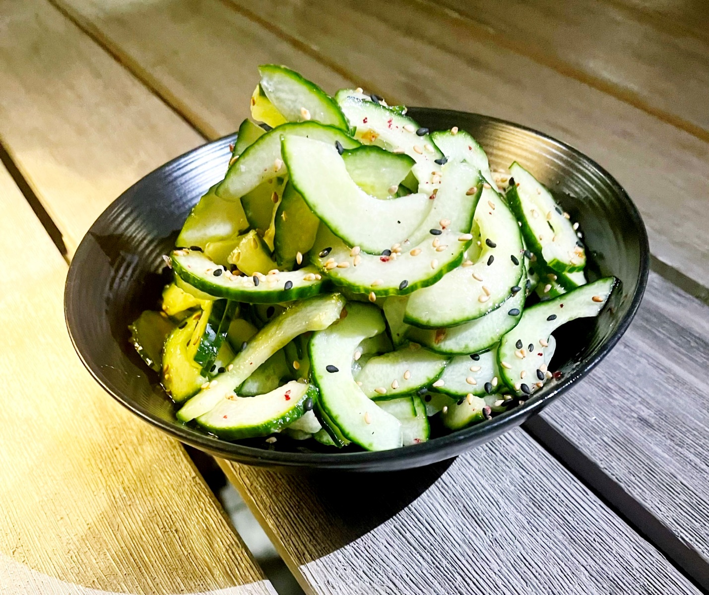 A bowl of cucumber salad Description automatically generated