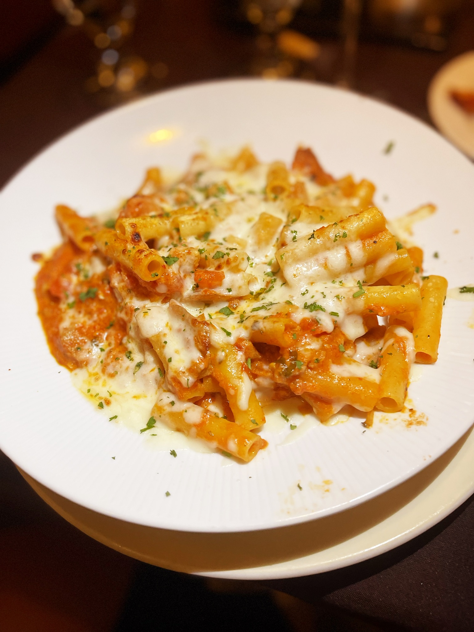 A plate of pasta with cheese and sauce Description automatically generated with medium confidence