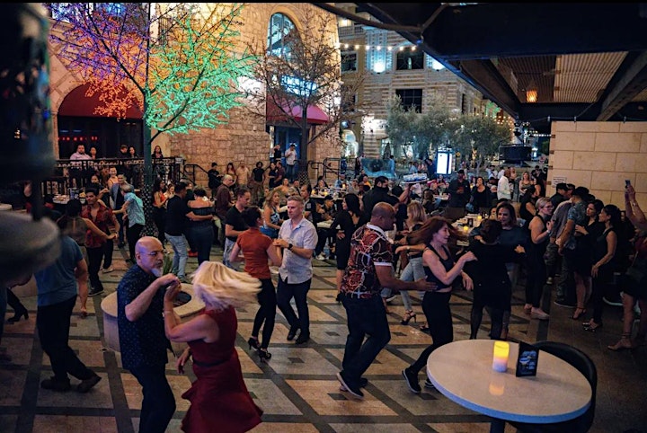 A group of people dancing outside

Description automatically generated