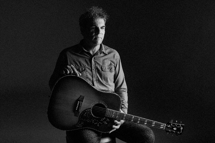 A person holding a guitar

AI-generated content may be incorrect.