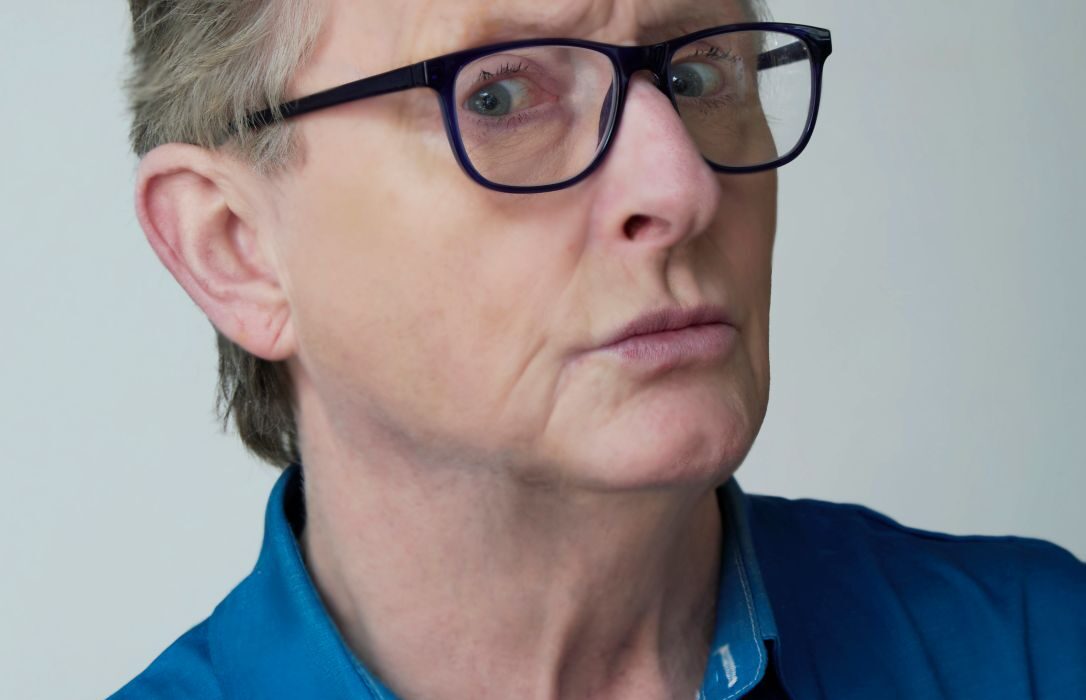 A person wearing glasses and a blue shirt AI-generated content may be incorrect.